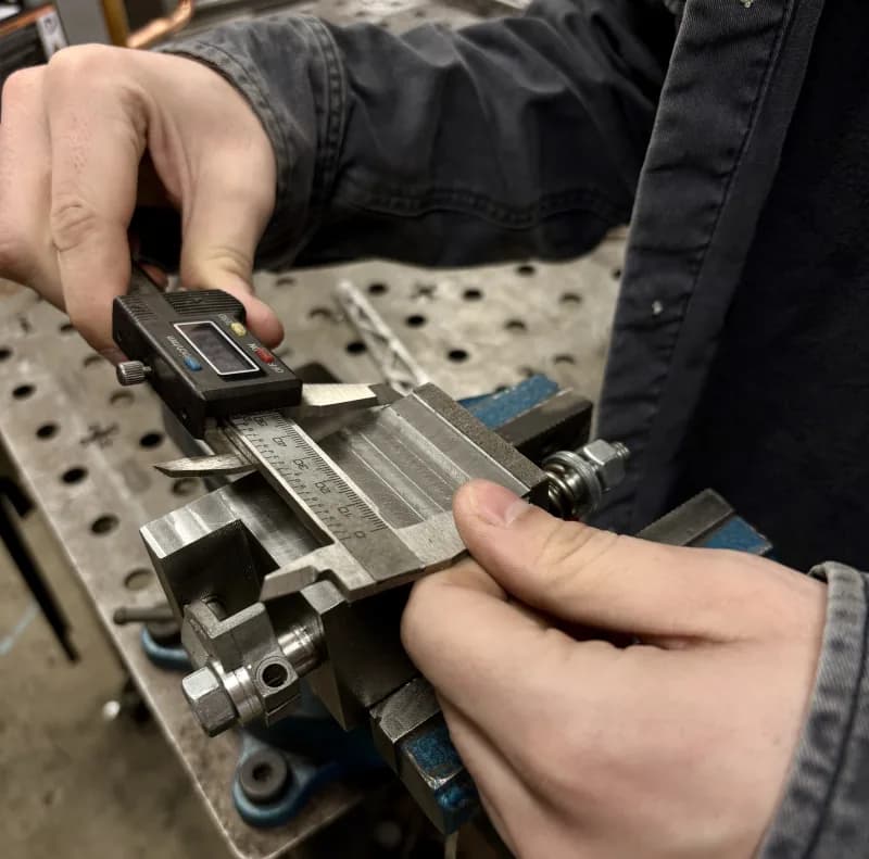 Measuring a machined part with digital calipers